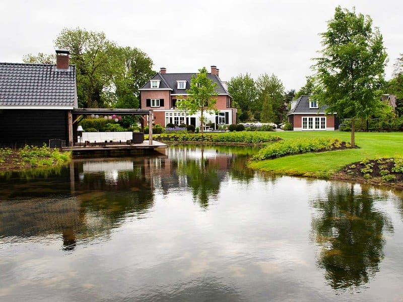 Charming Dutch home appears to float on a waterside canal