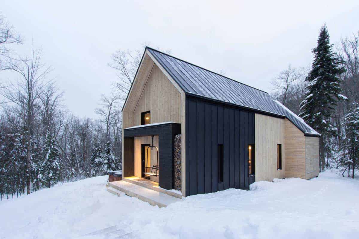 Scandinavian-inspired cottage surrounded by forest in Quebec
