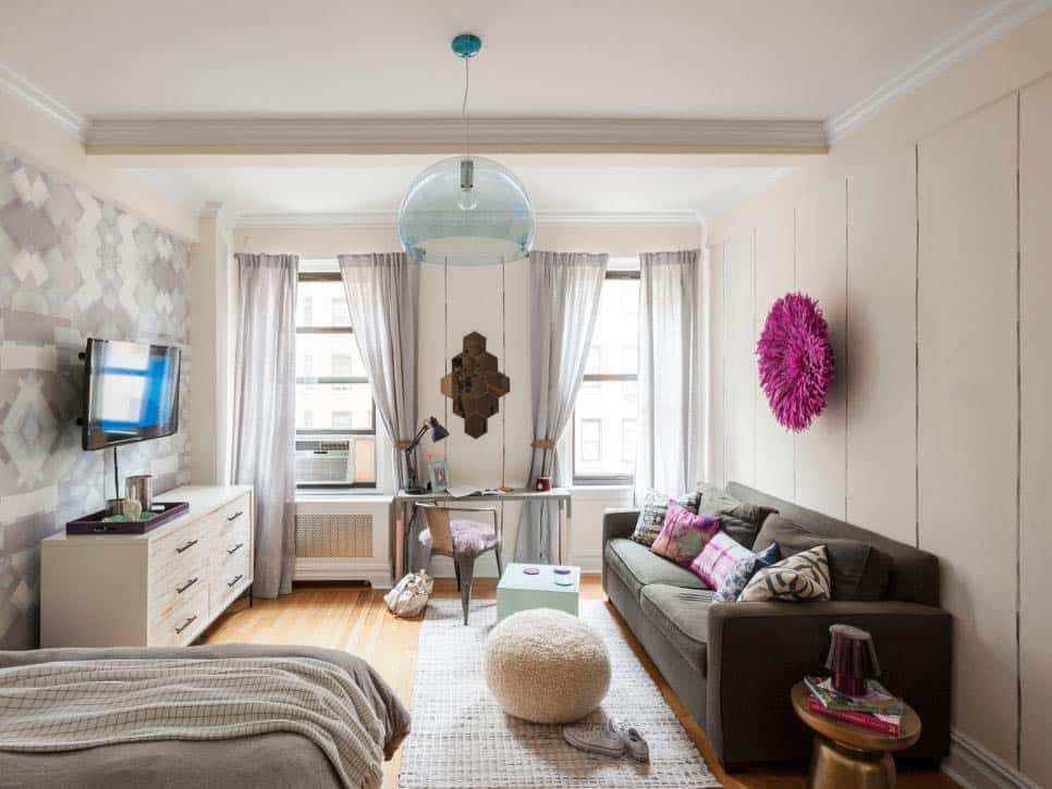 small-studio-apartment-with-a-sofa-desk-and-bed