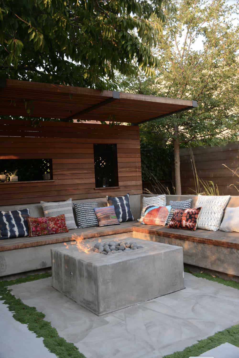outdoor fire pit with a built-in bench seat and cushions