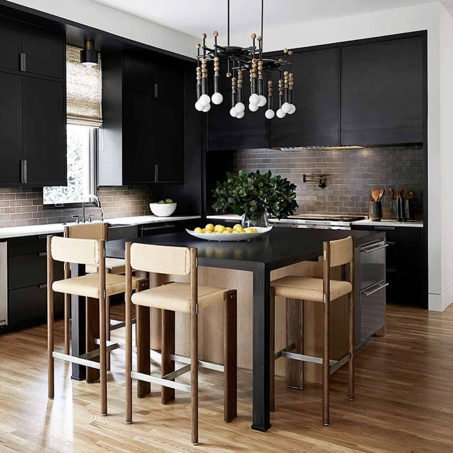 black and moody kitchen with a large square island