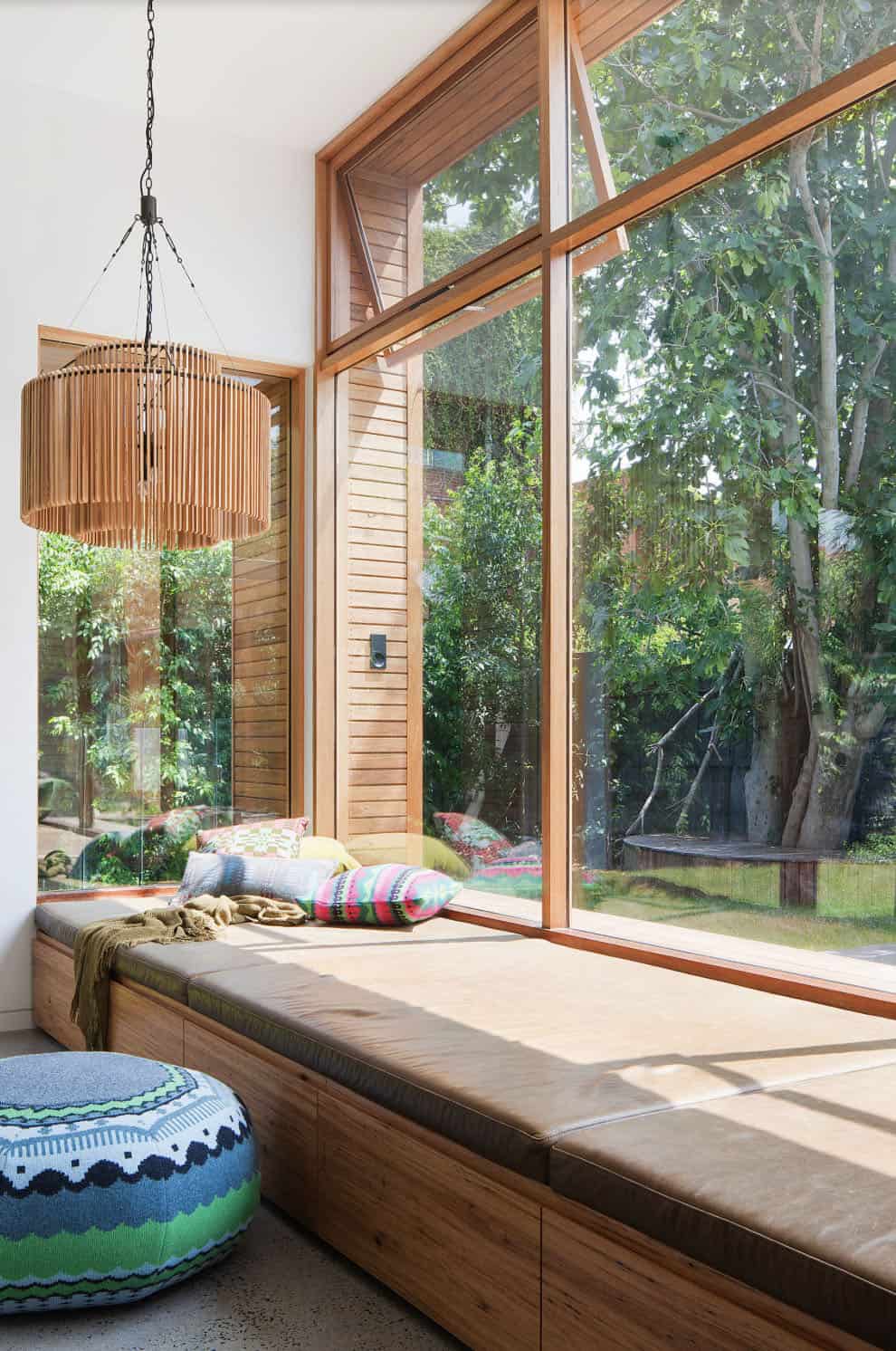 contemporary living room with a deep window seat and overhead chandelier