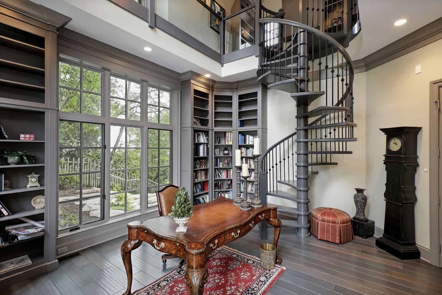 traditional-style-home-office-with-a-library-and-spiral-staircase