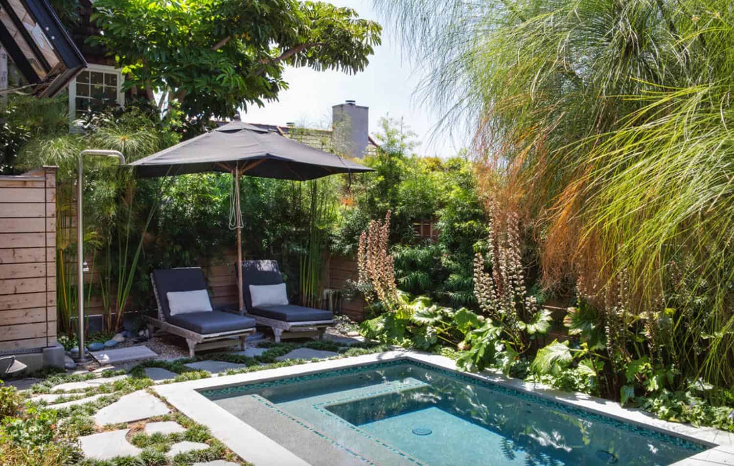 small rectangle pool with sitting area right beside it with umbrella and chairs 