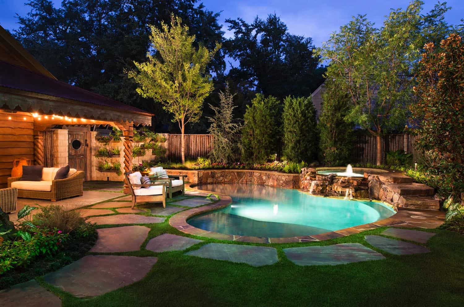 pool with rock siding, a sitting area under a pergola with lights