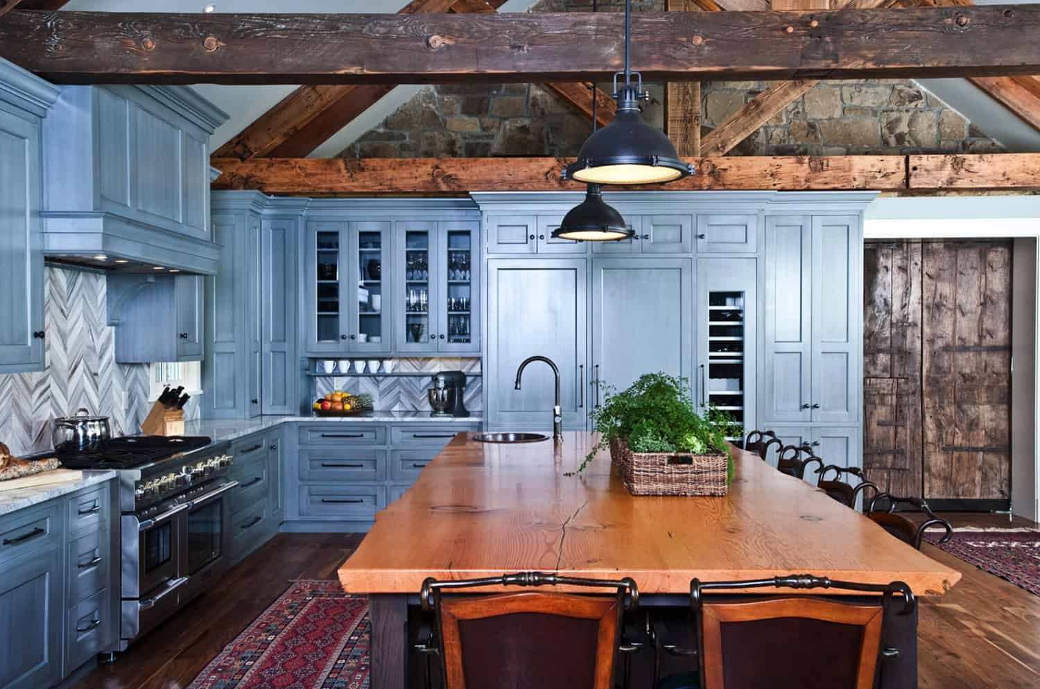 rustic-stone-wall-kitchen-with-blue-painted-cabinets