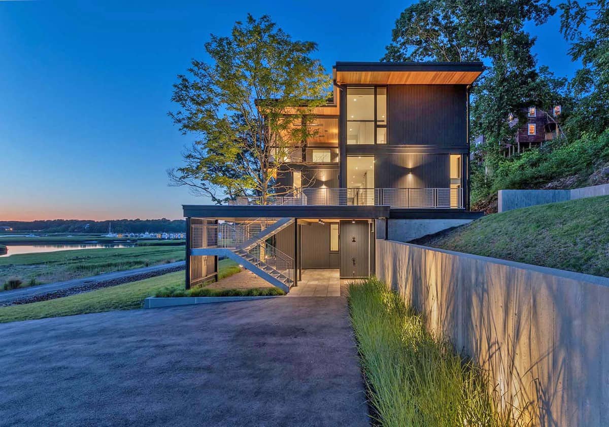 Galvanized steel home offers a woodland escape on the Annisquam River