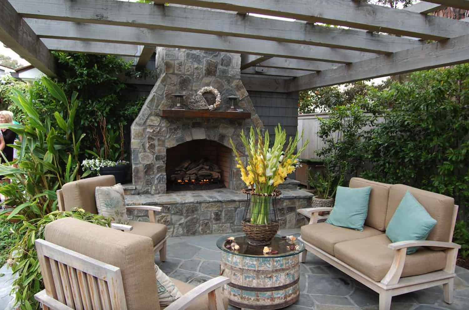 beach-style-outdoor-fireplace-with-a-pergola