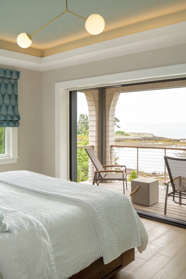 A modern shingle-style home rests peacefully on the Maine coast