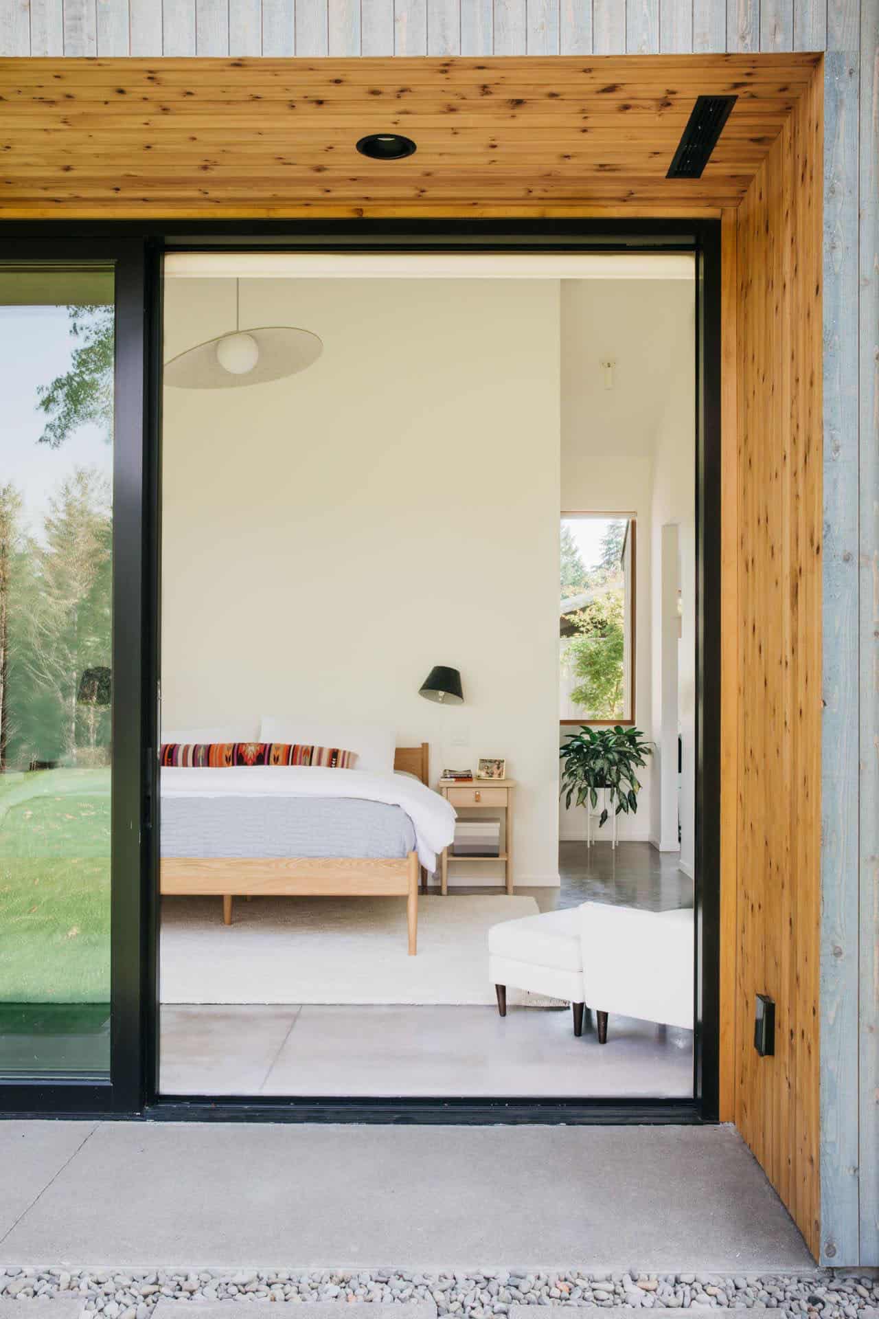 modern-scandinavian-home-exterior-with-sliding-glass-door-into-the-bedroom