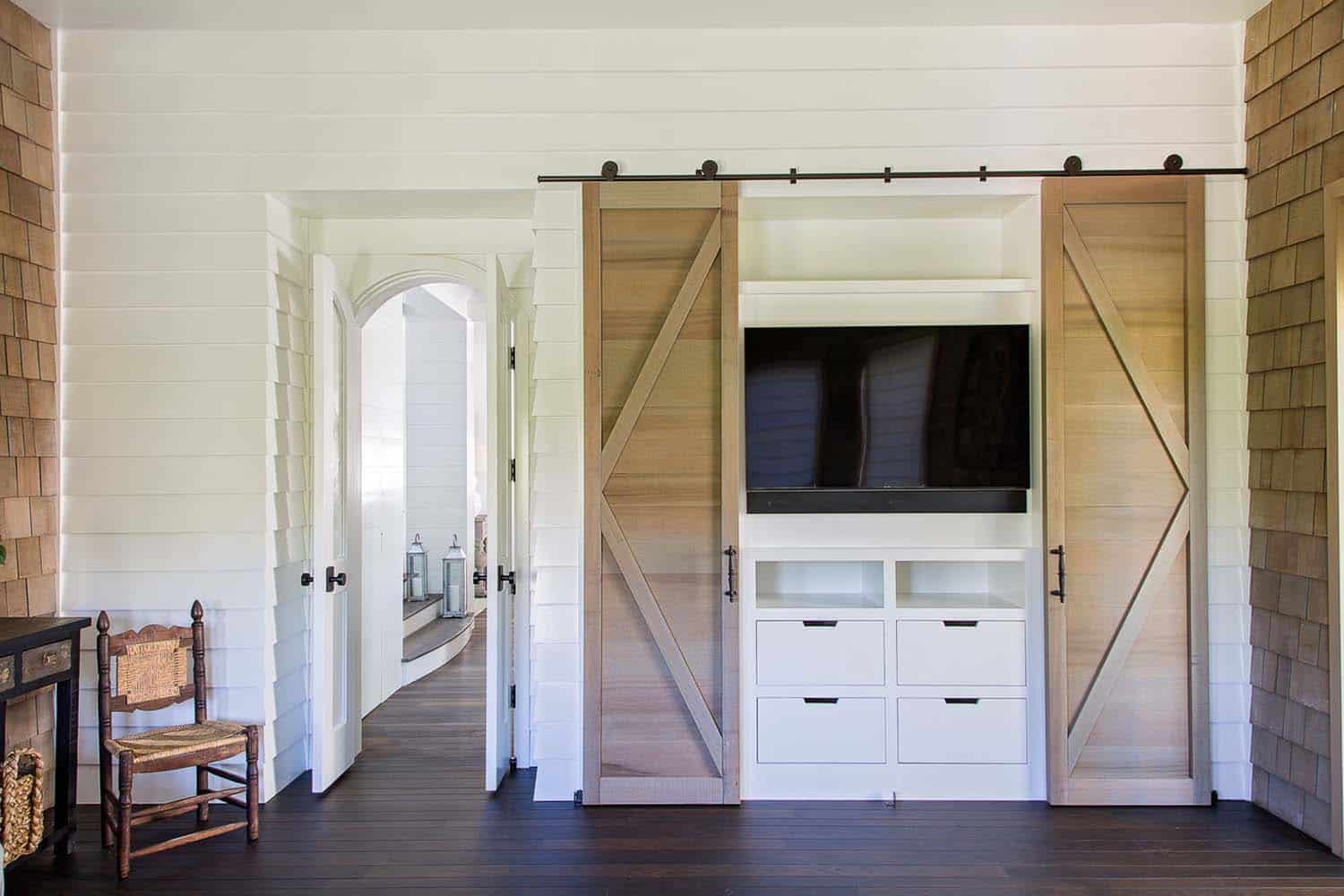 beach-style-built-in-entertainment-center-with-sliding-barn-doors