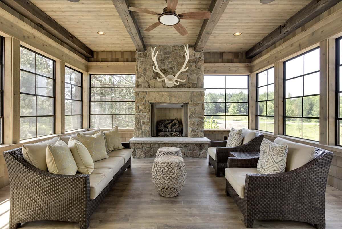 cozy rustic sunroom with a fireplace