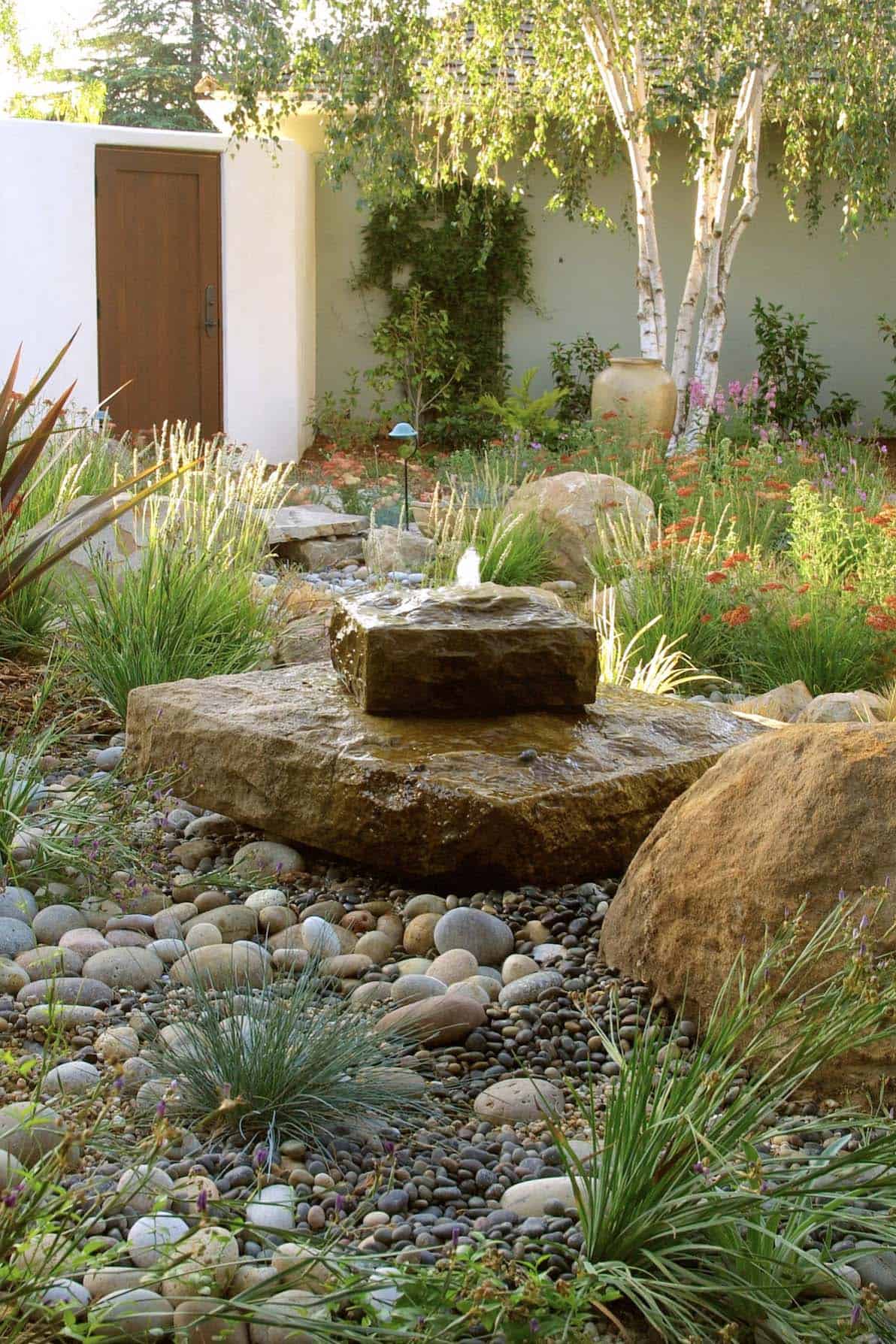 water-fountain-surrounded-by river-rocks
