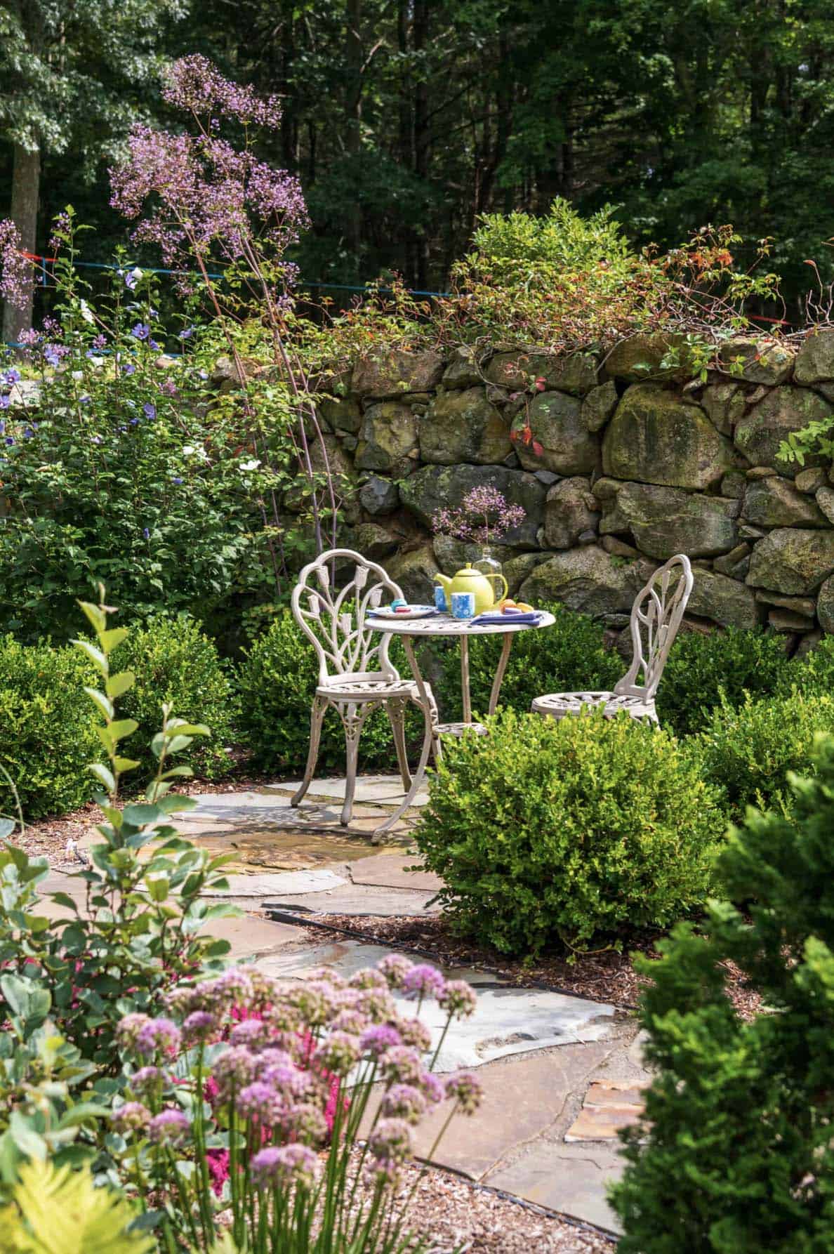 colorful-garden-with-flowers-and-bistro-dining-set
