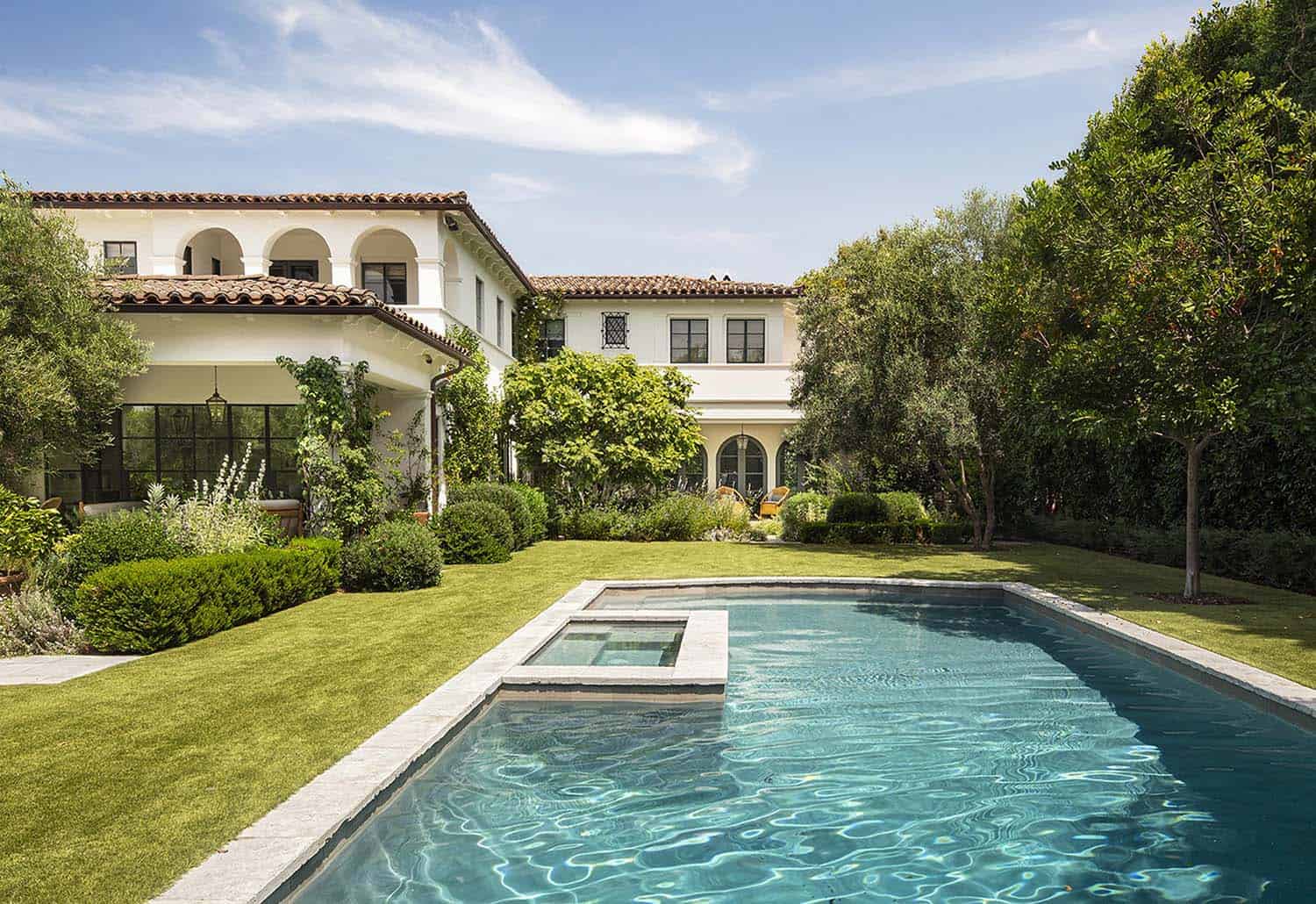 mediterranean-revival-home-exterior-with-a-pool
