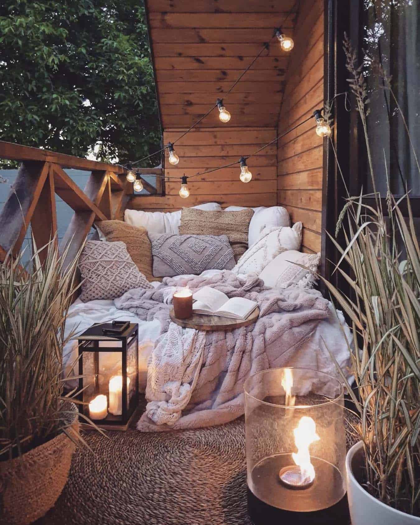 cozy outdoor balcony with a daybed and string lights