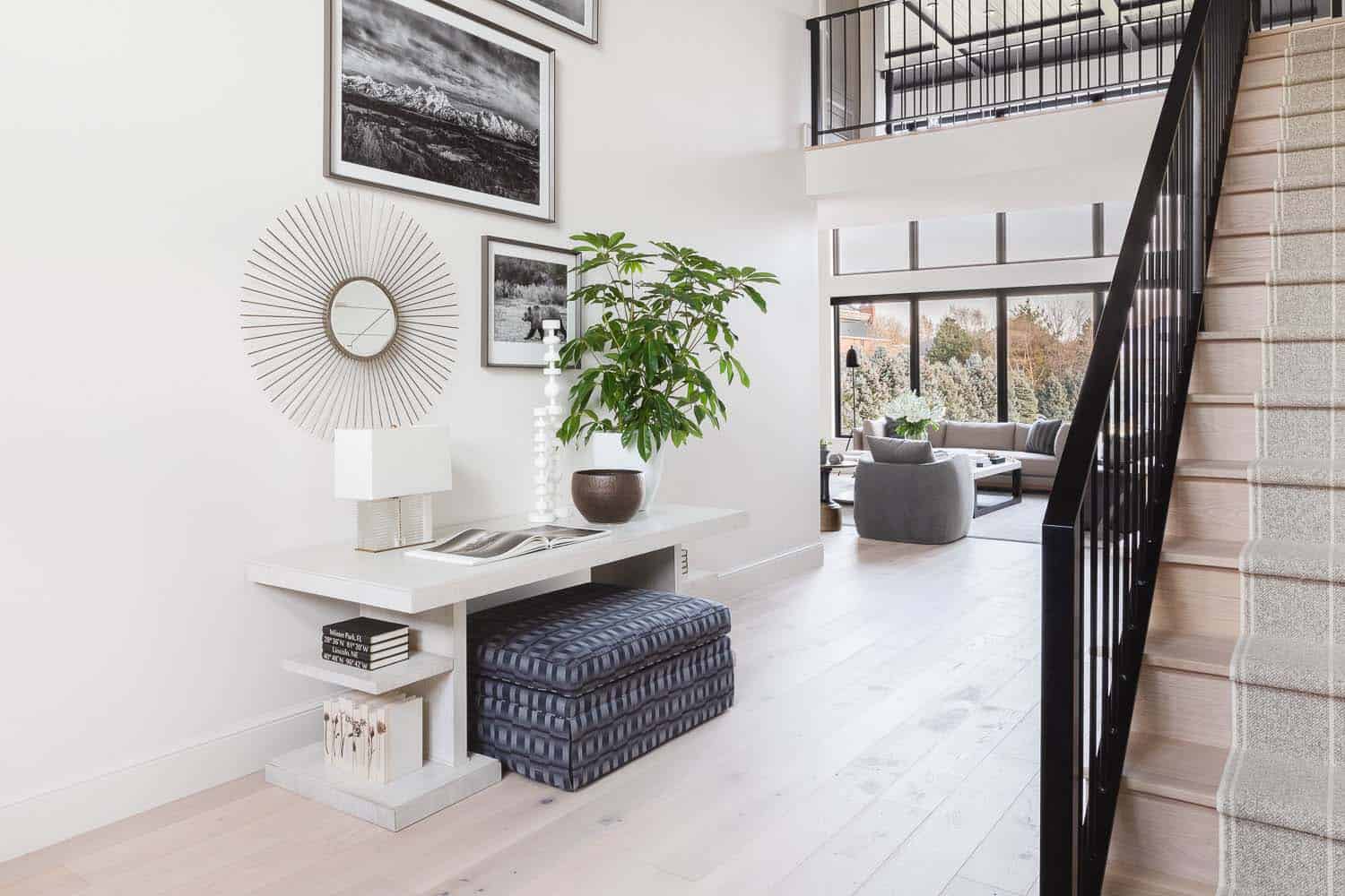 transitional style home entry with a staircase and high ceiling