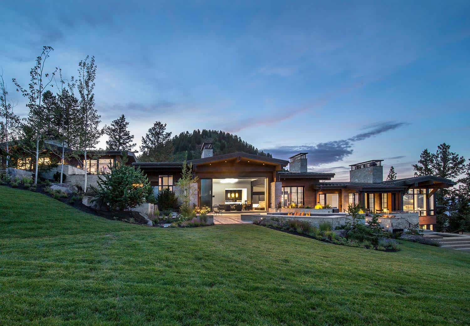 mountain home exterior at dusk backyard view