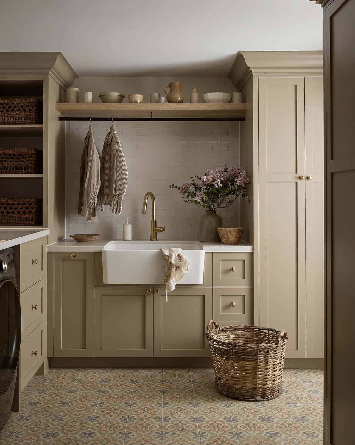 transitional style laundry room with a sink