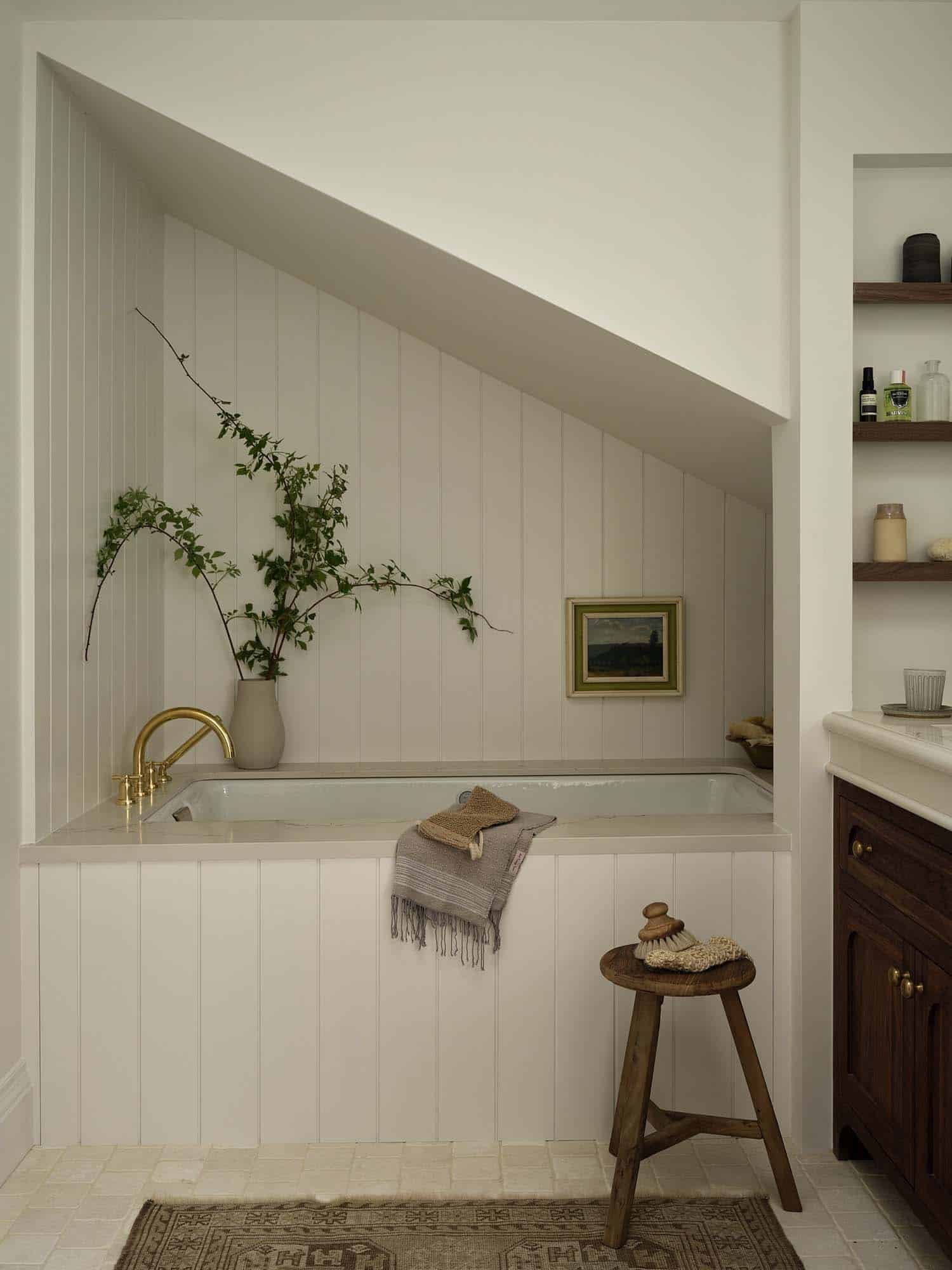 contemporary bathroom with a tub and angled ceiling