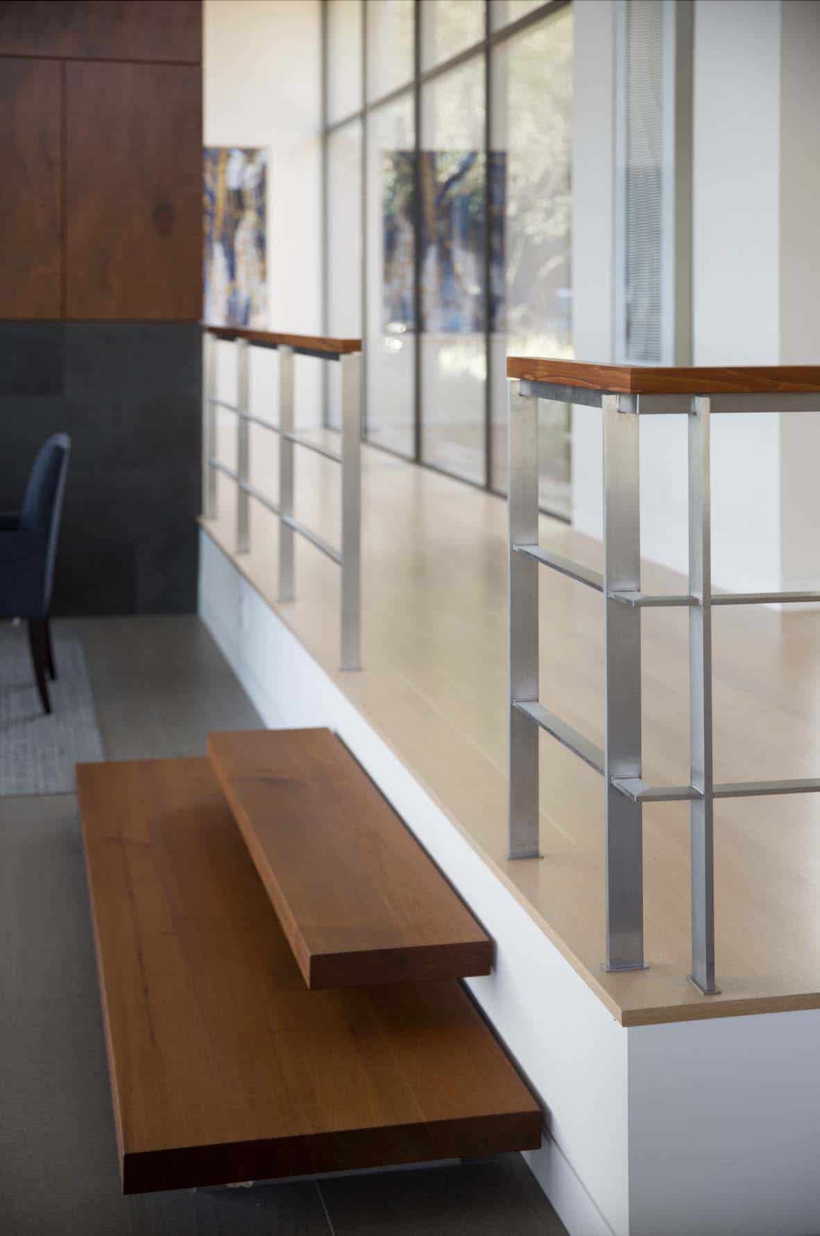 raised upper hallway with two floating steps down to the main floor