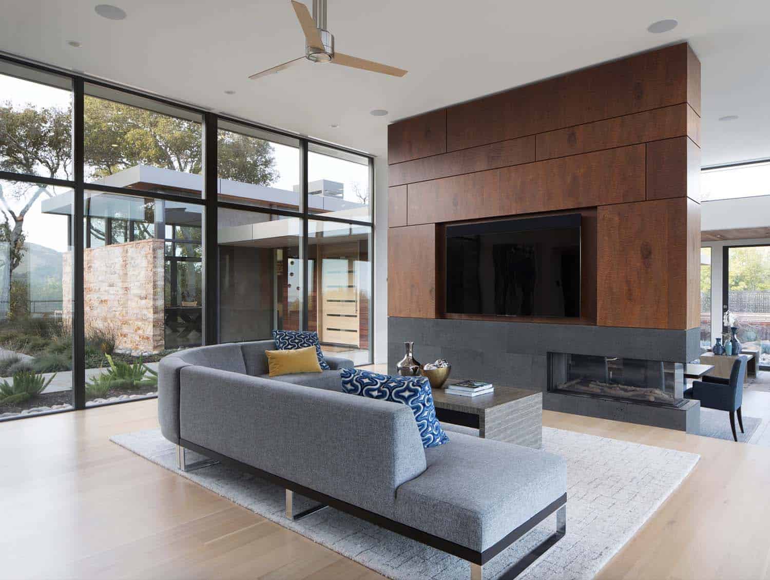 modern family room with a fireplace and tv