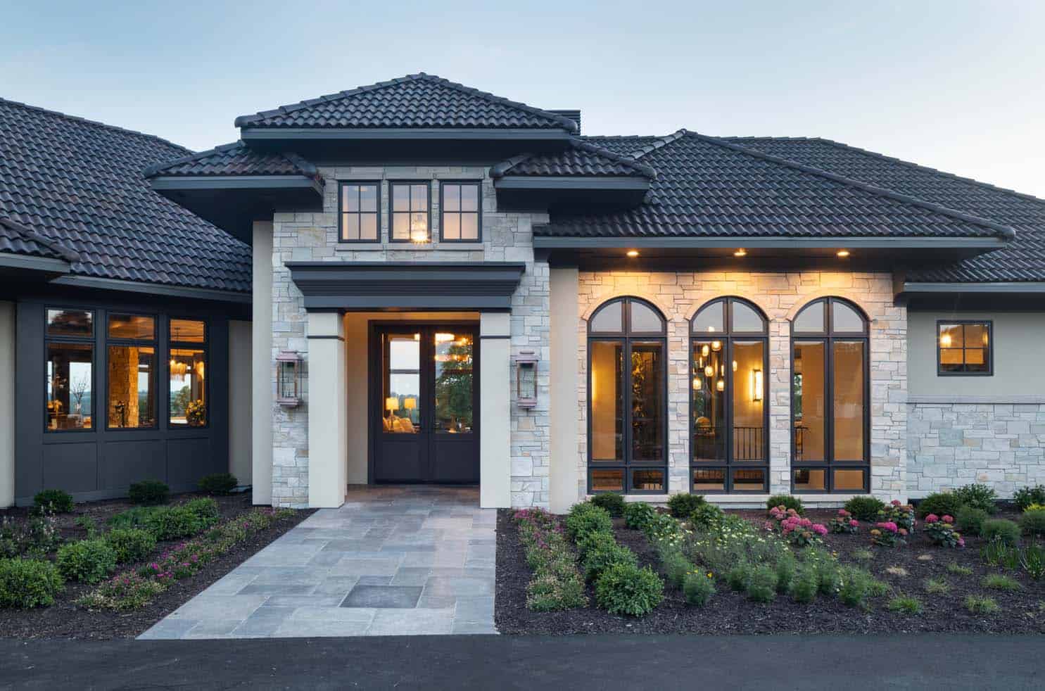 modern tuscan inspired house exterior at dusk 