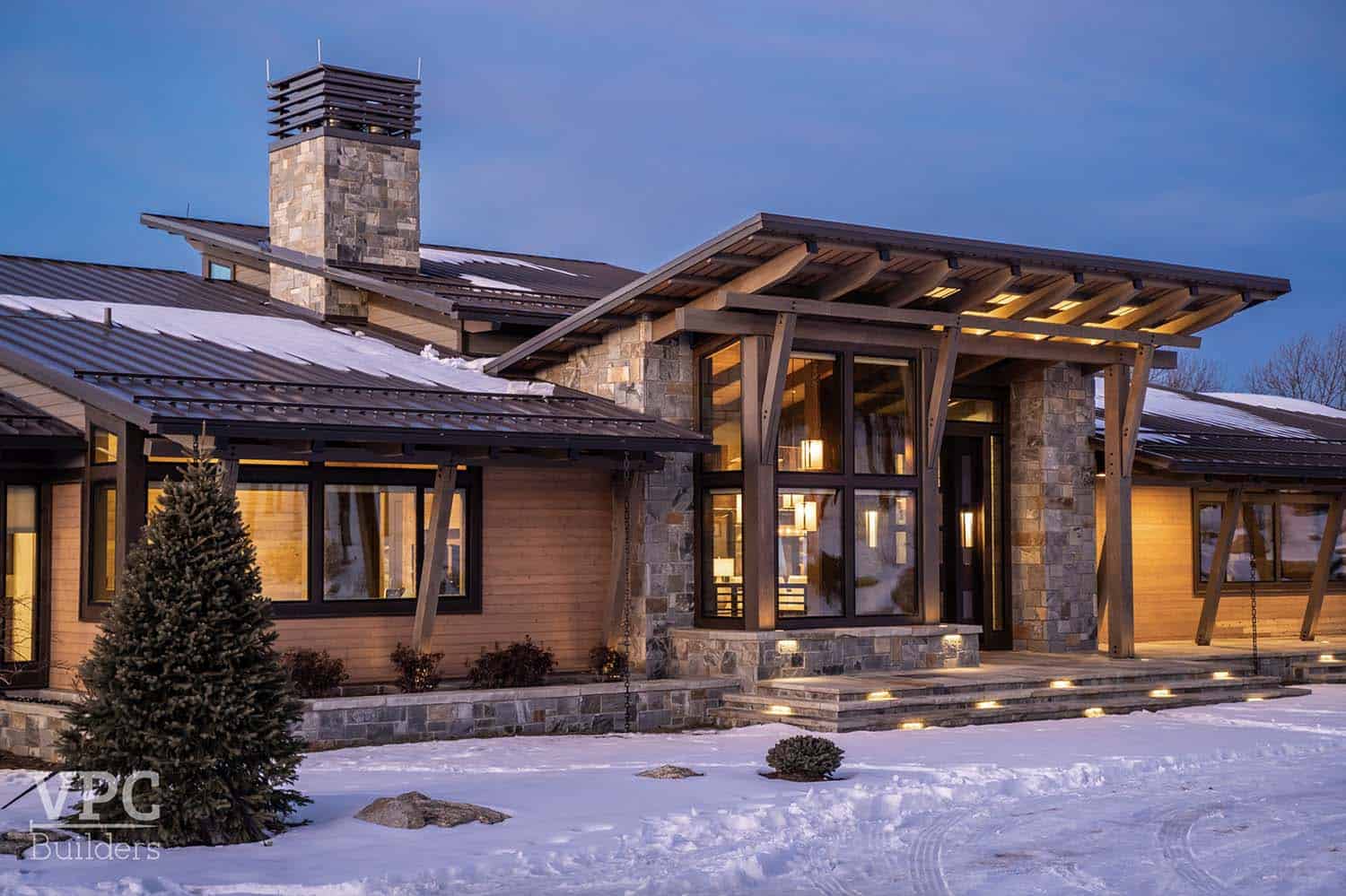modern mountain lodge exterior at dusk
