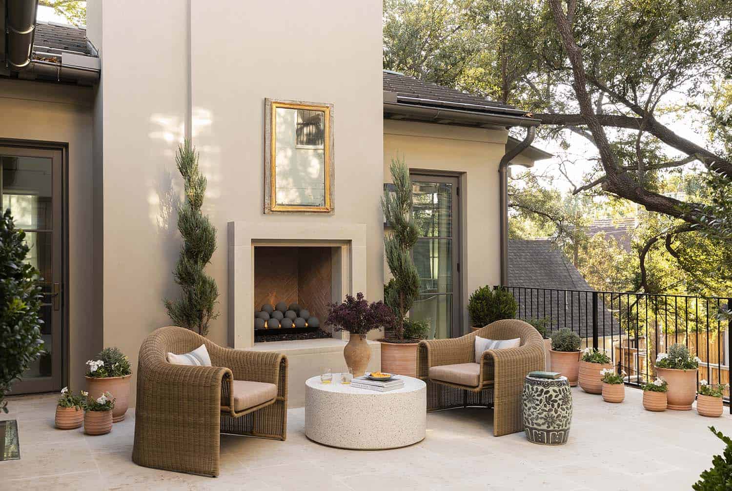 French provincial outdoor patio with a fireplace