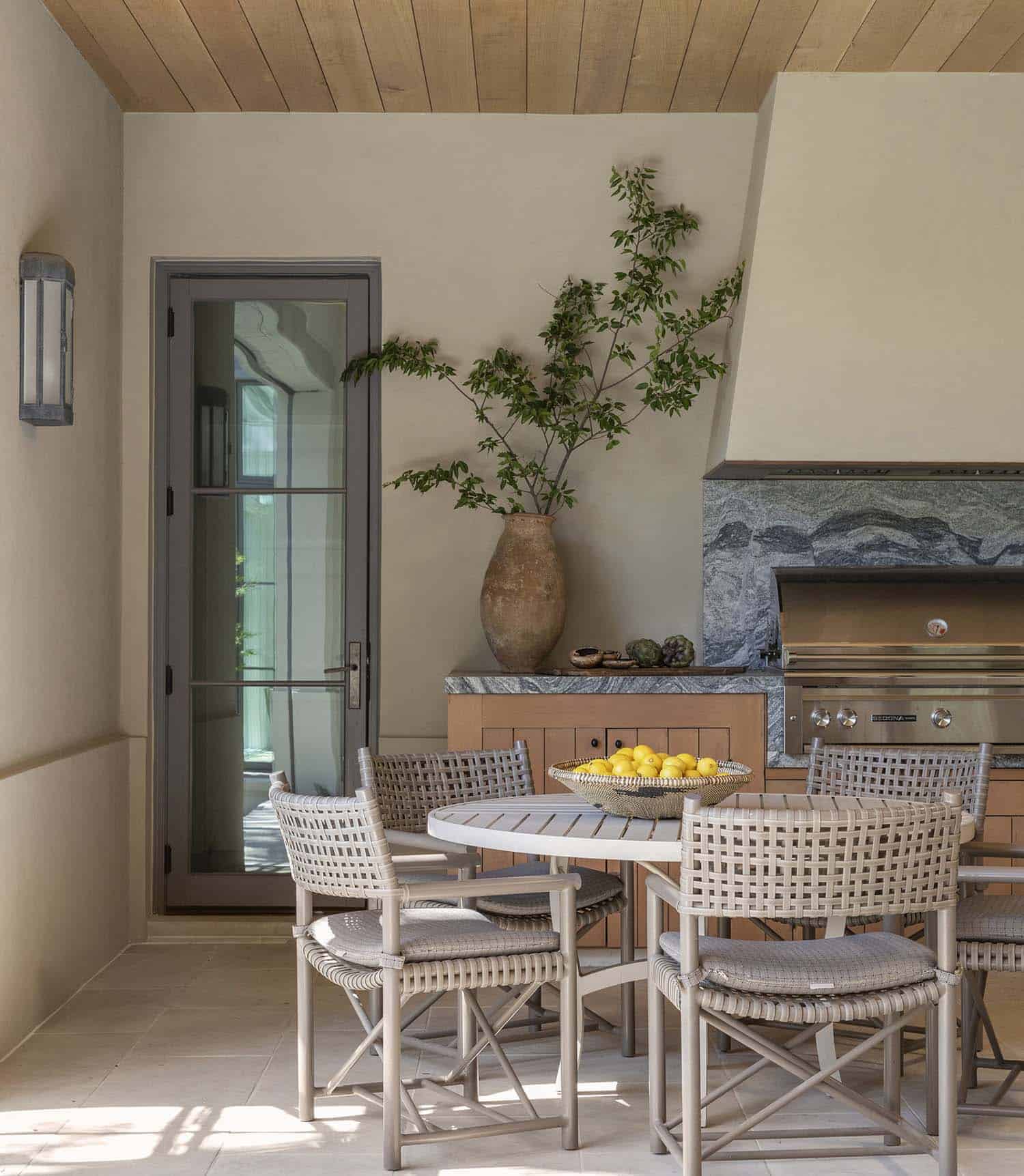 French provincial outdoor kitchen with a grill and dining area