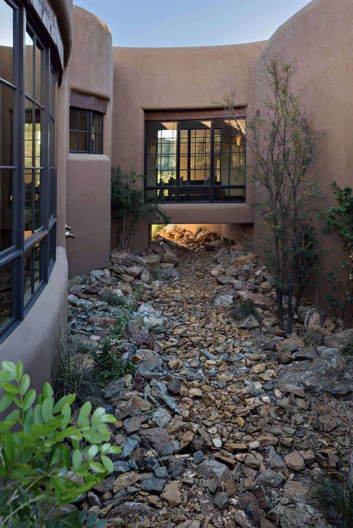 southwestern style home exterior with a bridge