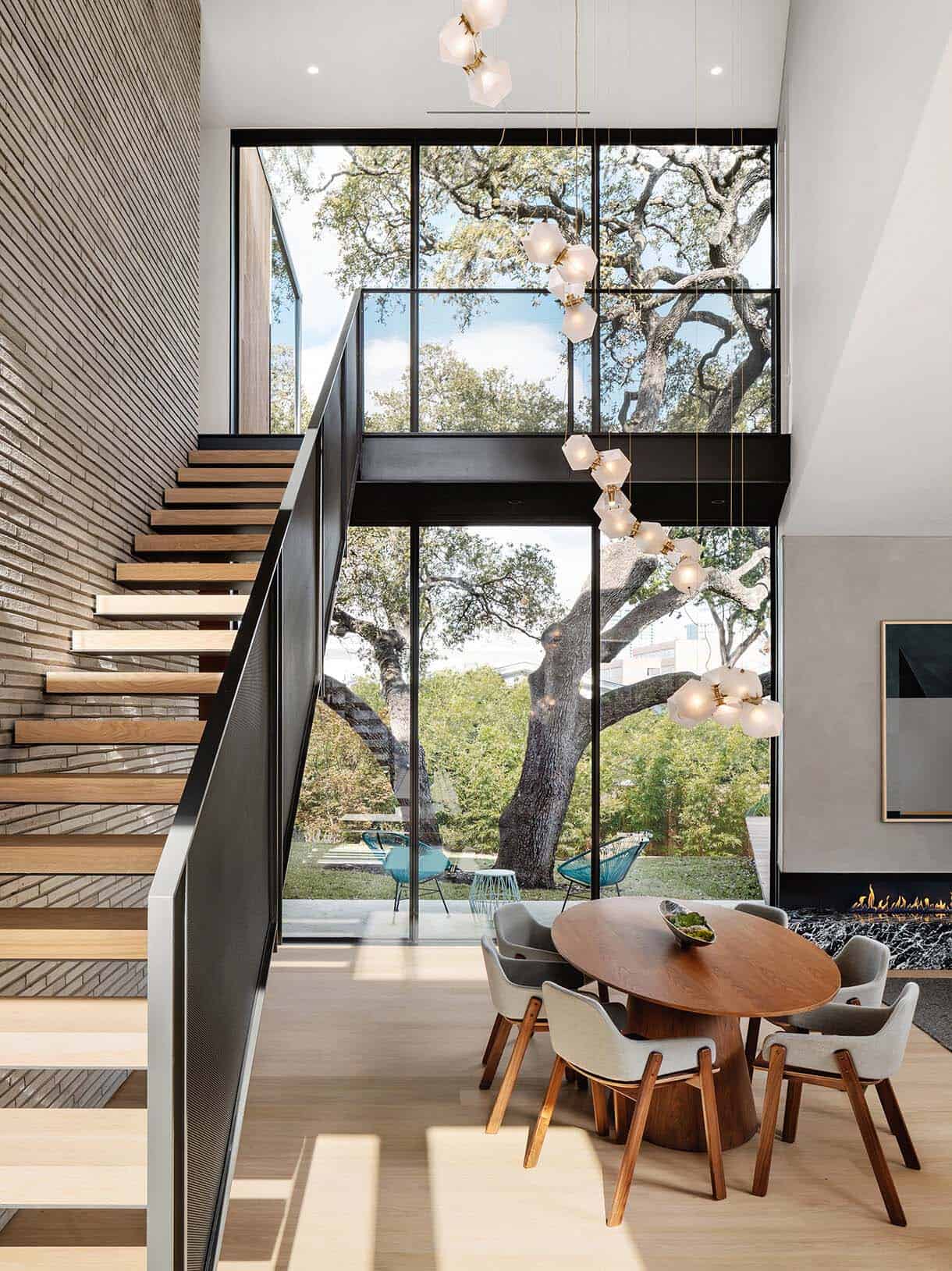 modern staircase and dining room with large windows