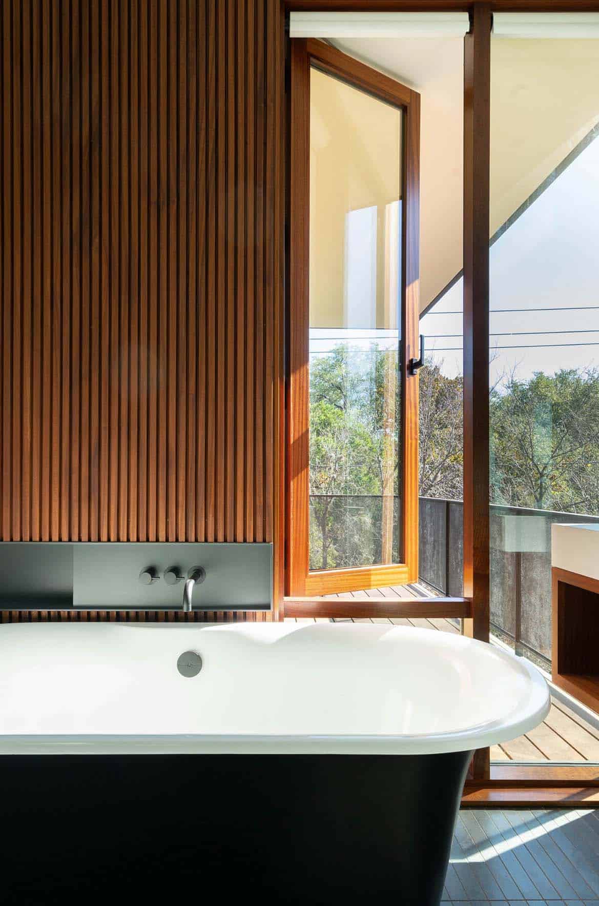 modern bathroom with a freestanding tub and operable window