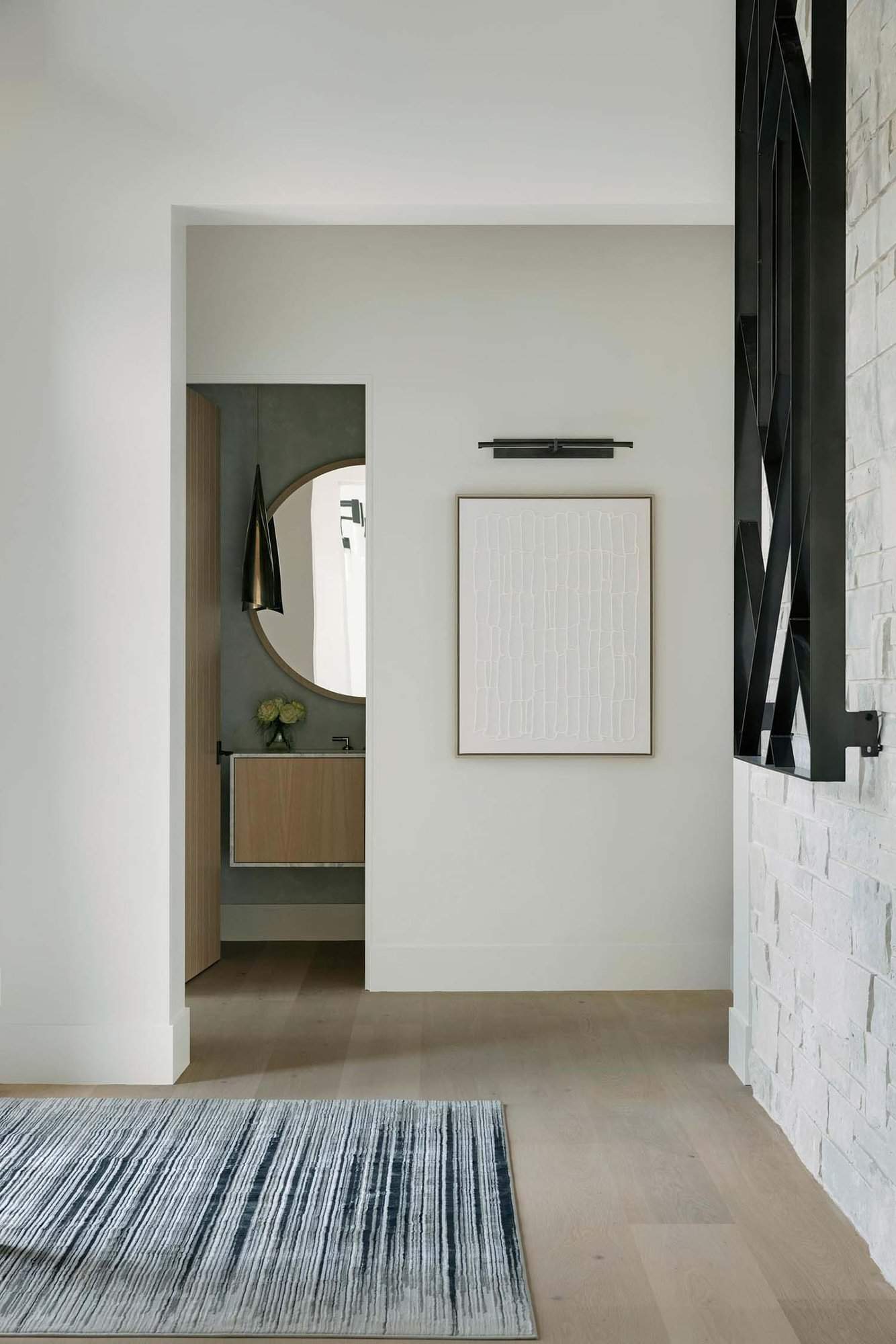 modern rambler home entry with a view to the powder room