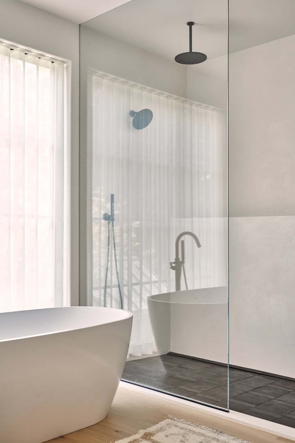 nordic-inspired bathroom with a freestanding tub and shower