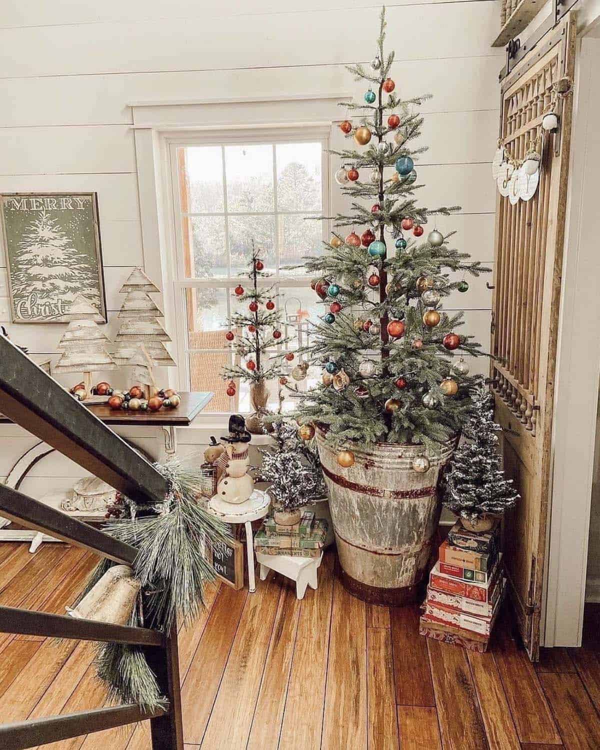 rustic christmas decorated front entry with a tree