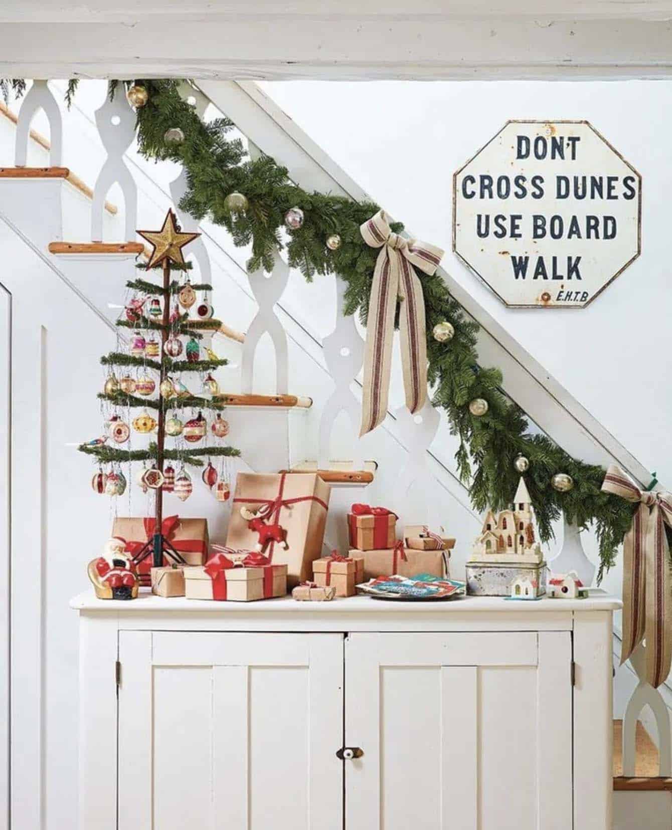 vintage-inspired Christmas decor on the staircase with a garland