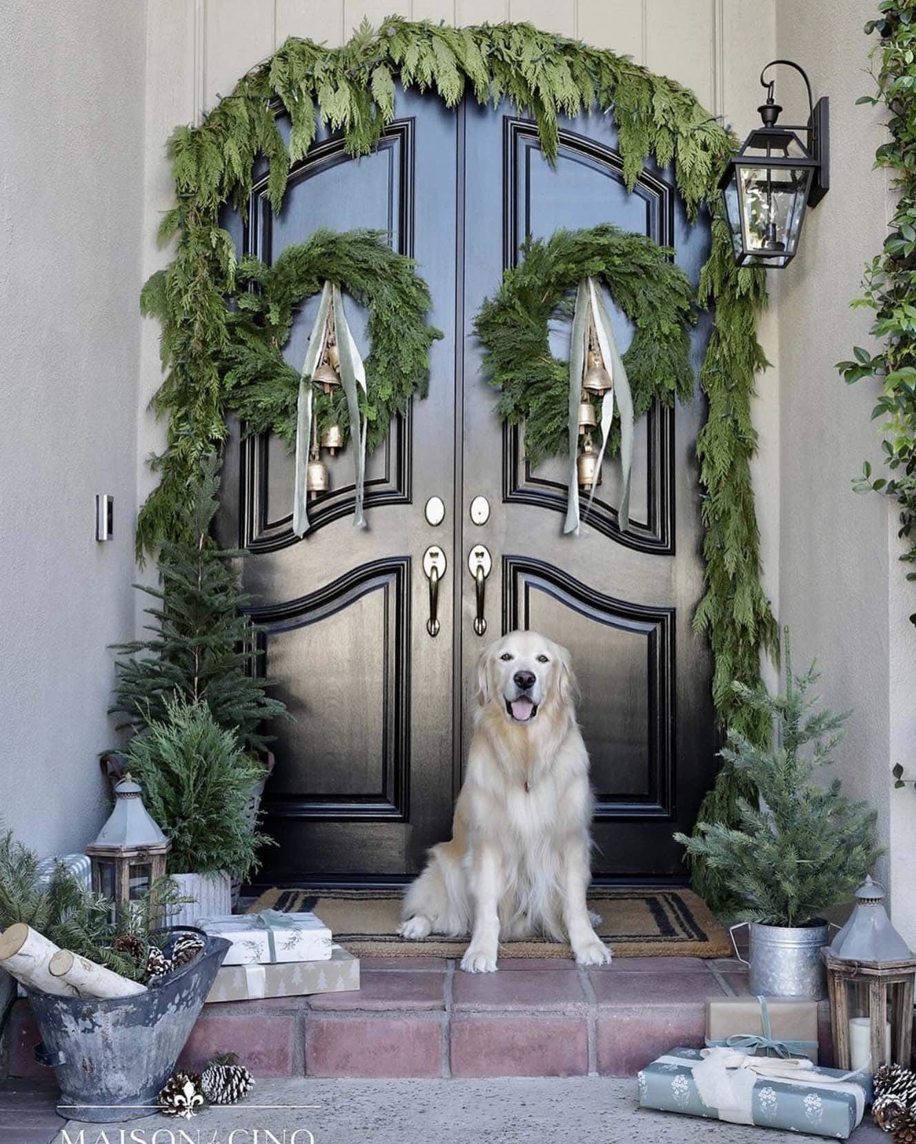 christmas decorated front porch with garland and wreaths