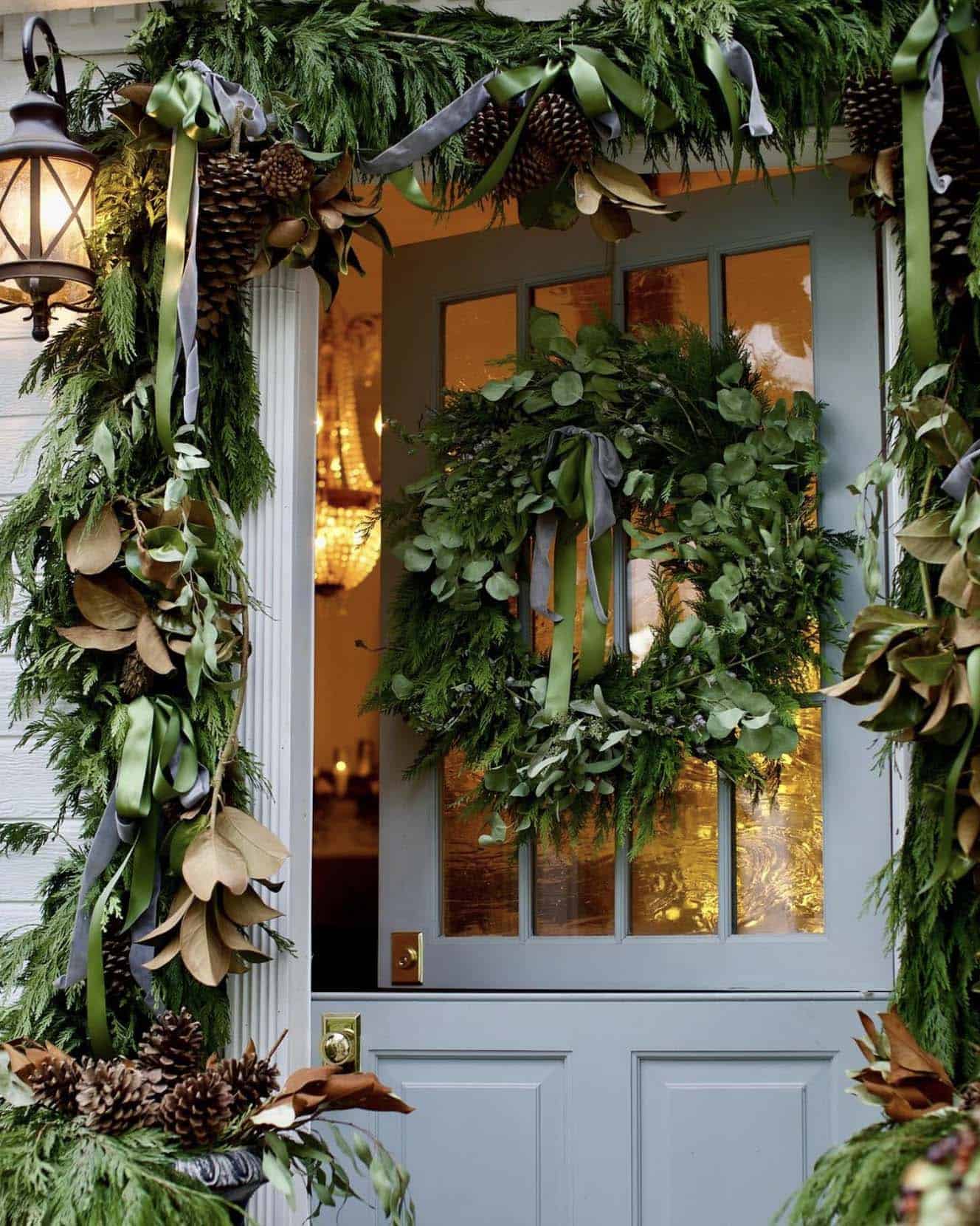front door with a christmas wreath and garland