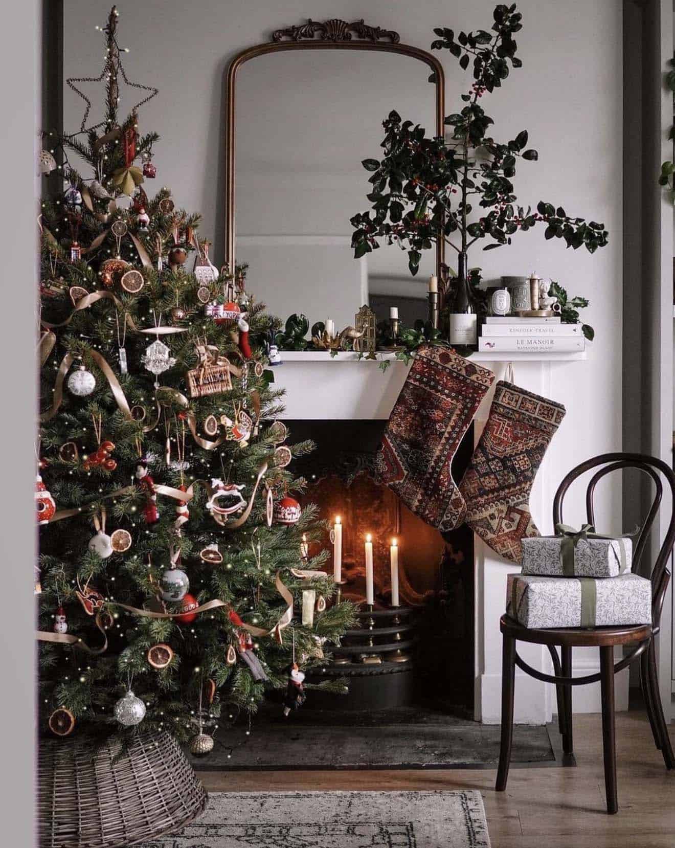 christmas tree in front of the fireplace with stockings