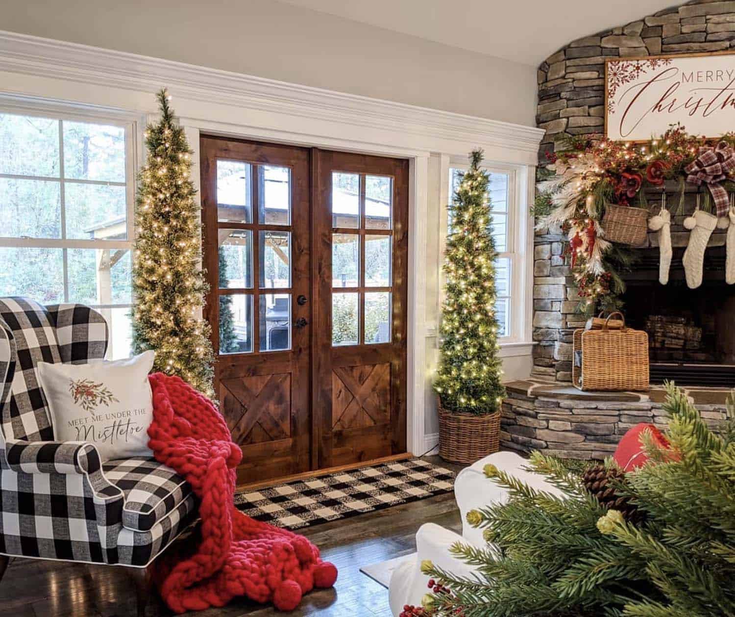 christmas decorated entry into the living room with pre-lit trees