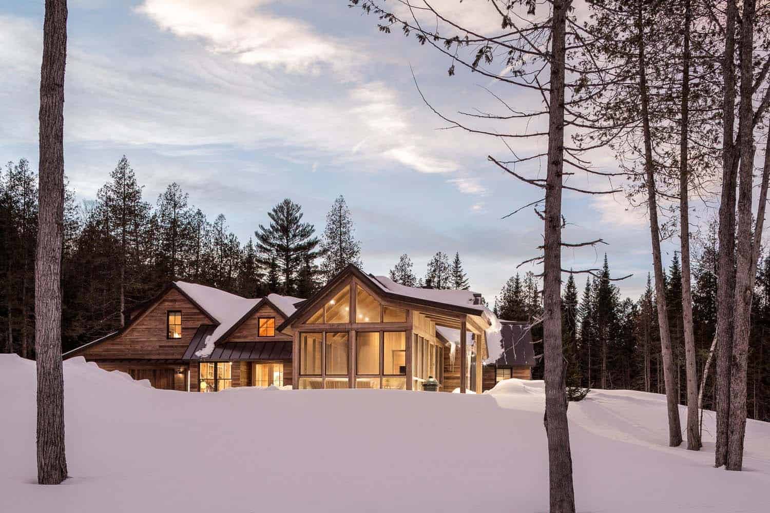 modern rustic mountain home exterior with snow