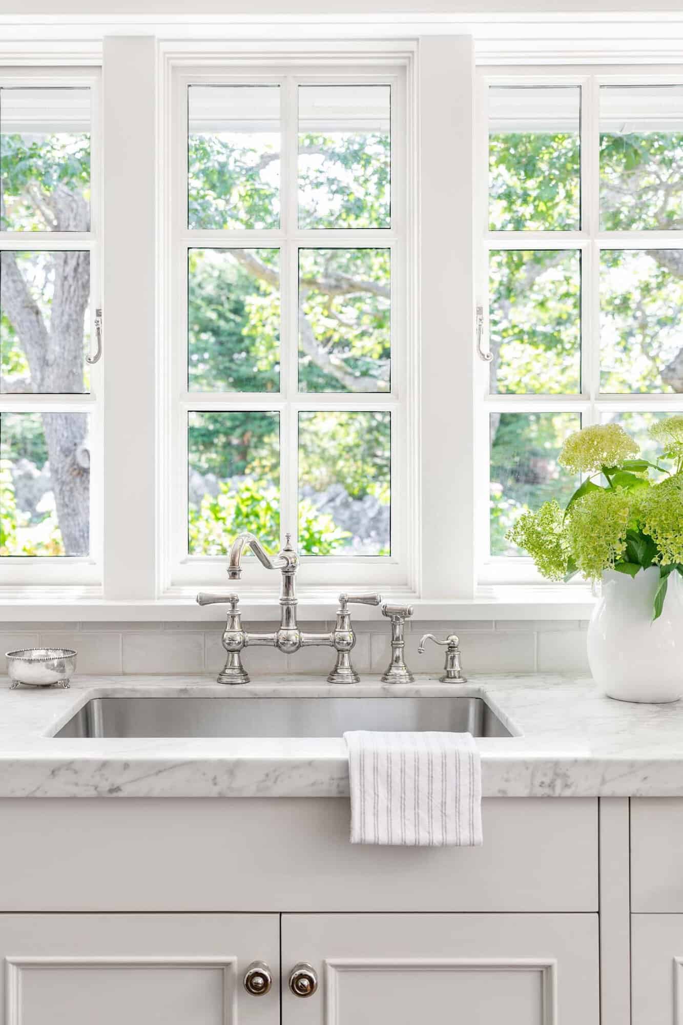 traditional kitchen with a view of the sink with a window above