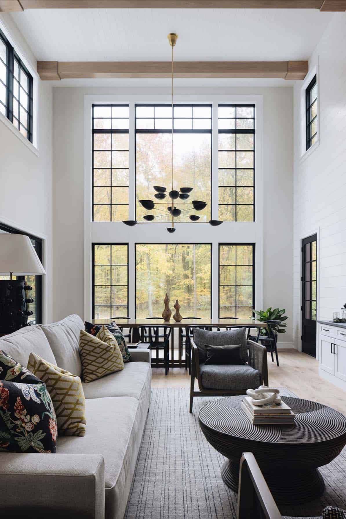 modern farmhouse style two-story great room with large windows