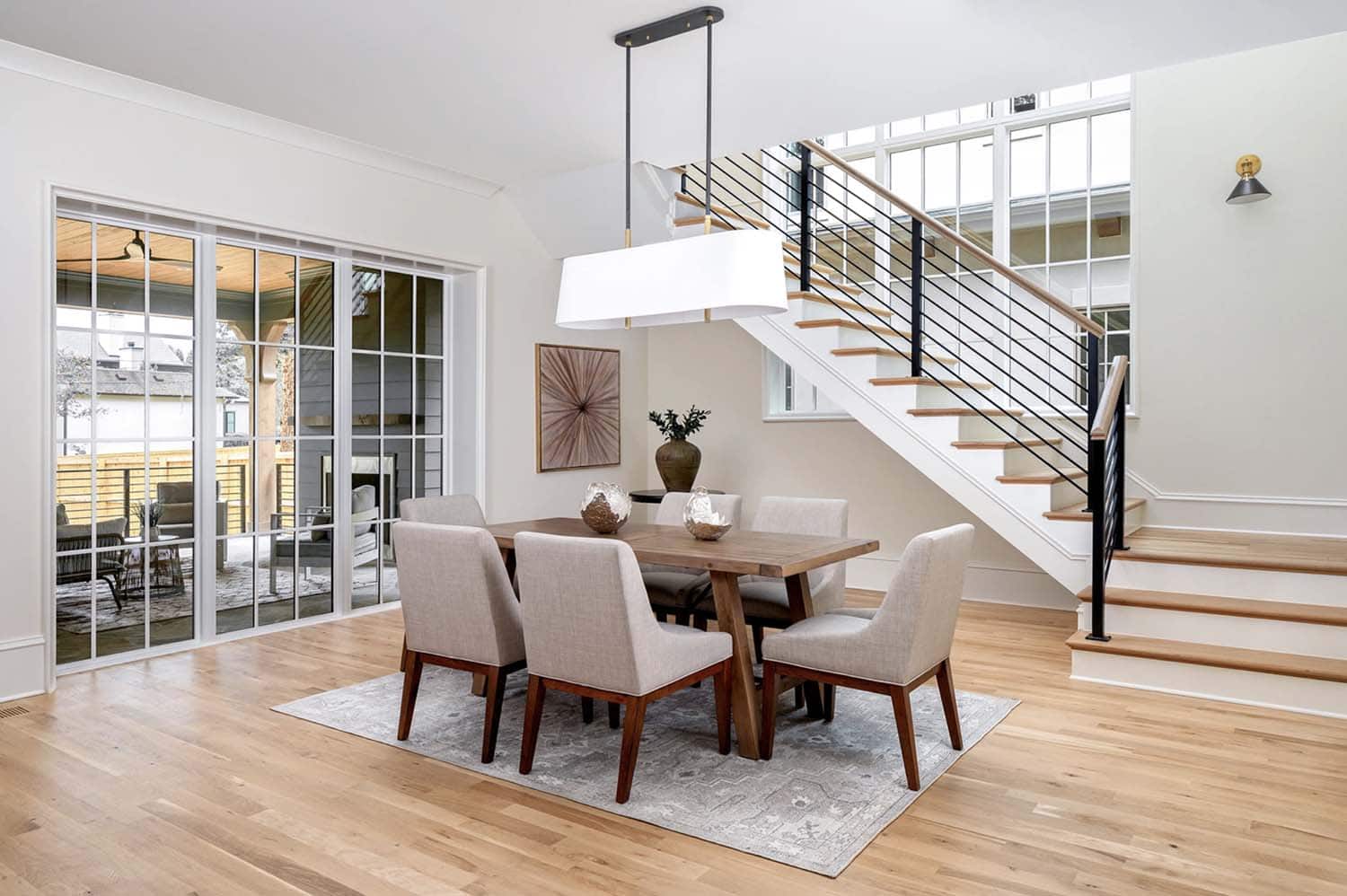contemporary dining room with a staircase 