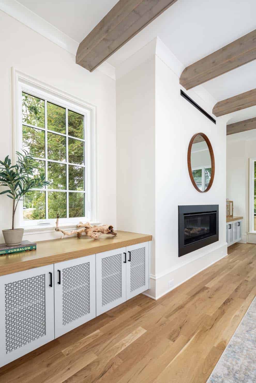 contemporary fireplace with built-in cabinets on either side