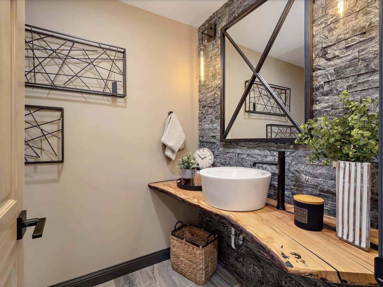 bathroom with a floating rustic wood vanity with a stone accent wall