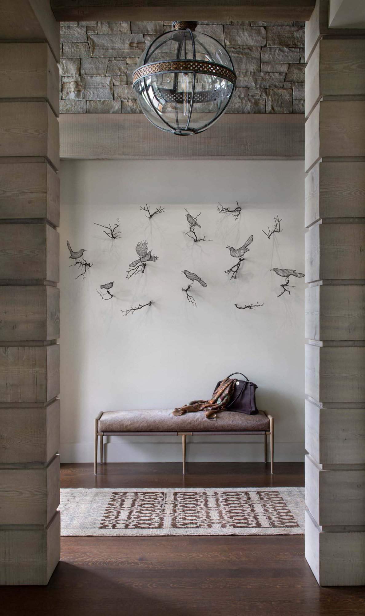 rustic mountain home entry bench with a wall art installation above