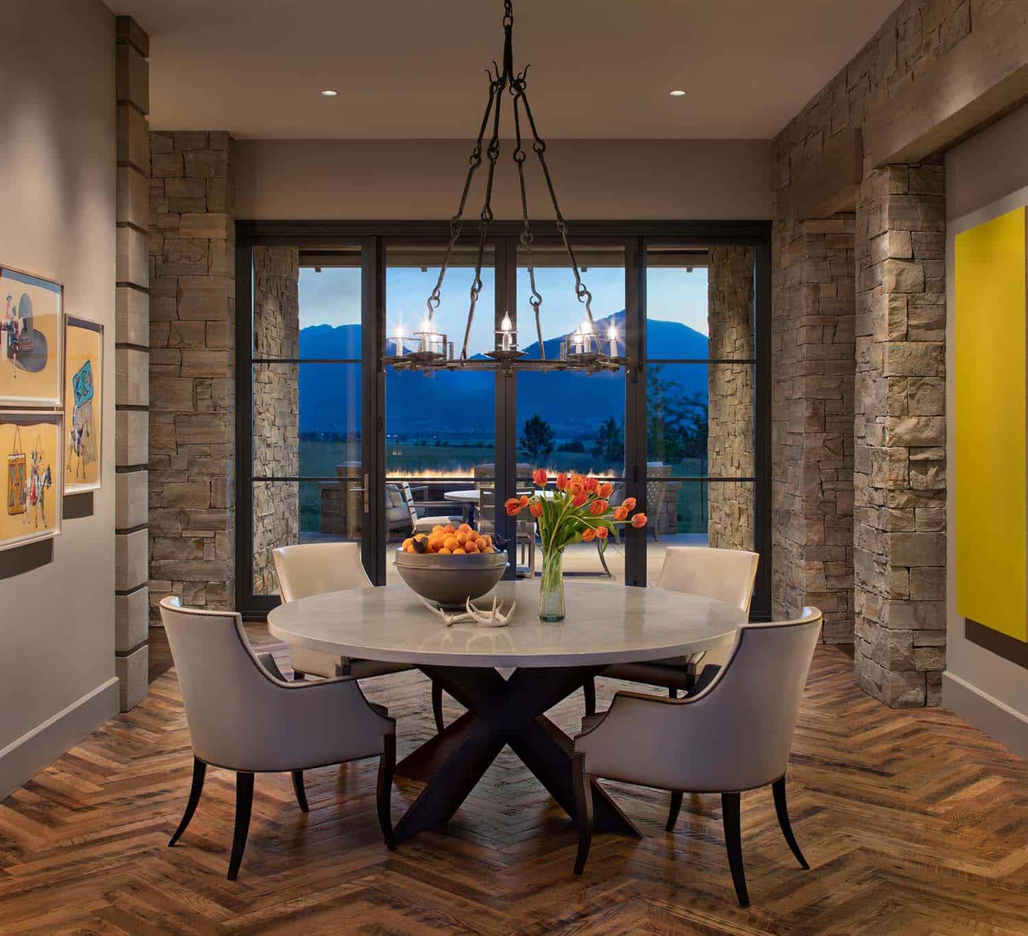 modern rustic dining room with a large window at dusk