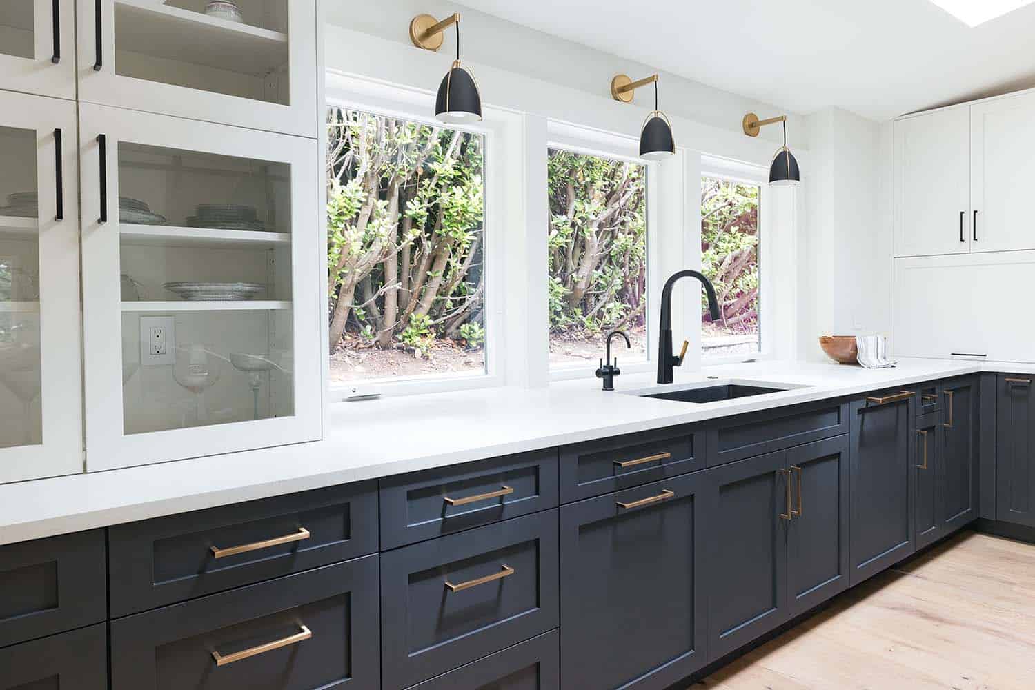modern kitchen with cabinets in front of a window and a sink